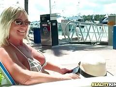 Guy meets pretty blond lady on pier and they decide to spend time on boat.